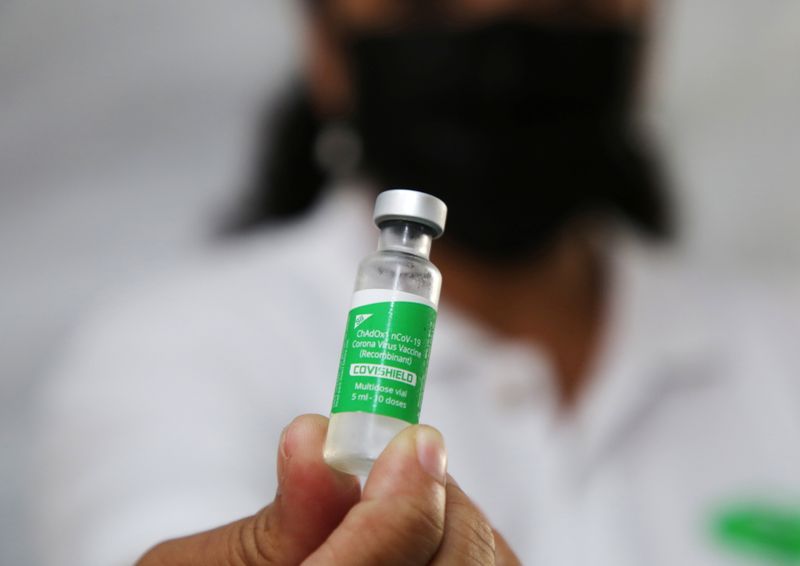 &copy; Reuters. A health worker holds a vial with doses of the Oxford-AstraZeneca vaccine, marketed by the Serum Institute of India (SII) as COVISHIELD, against the coronavirus disease (COVID-19), in Paramaribo