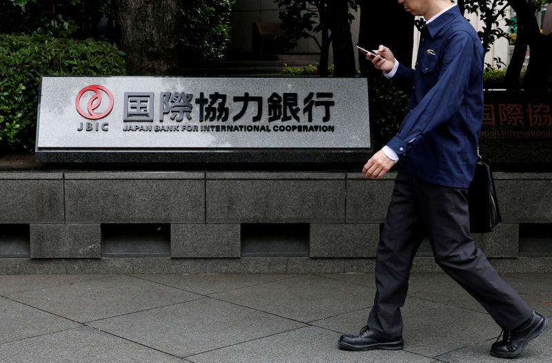 &copy; Reuters. FILE PHOTO: Man walks past a sign of Japan Bank for International Cooperation (JBIC) at it&apos;s headquarters in Tokyo