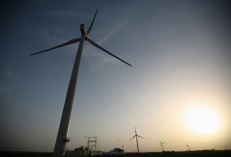 &copy; Reuters. Power generating windmill turbines are pictured during the inauguration ceremony of the new 25 MW ReNew Power wind farm at Kalasar village