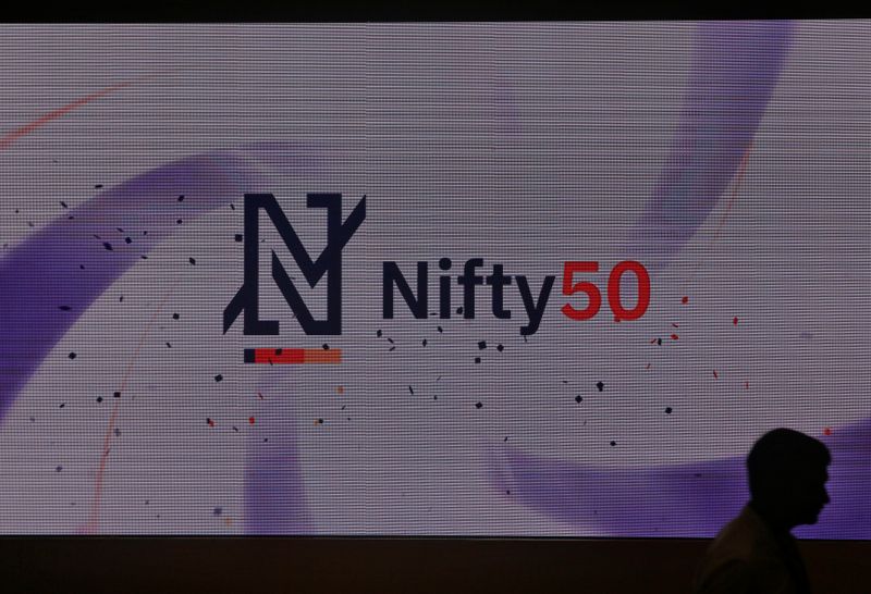 &copy; Reuters. A man walks past a newly launched Nifty Indices logo inside the National Stock Exchange building in Mumbai