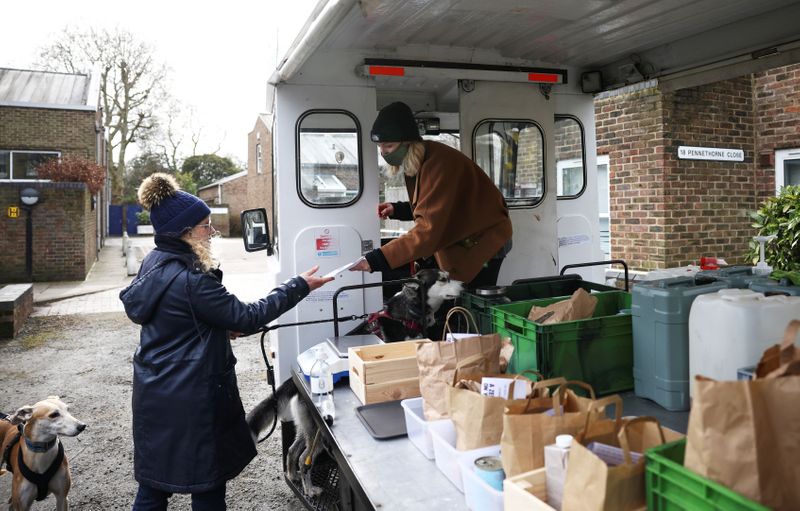 &copy; Reuters. Ella Shone, serves a customer from her mobile zero waste shop called the &apos;Top Up Truck&apos; in London
