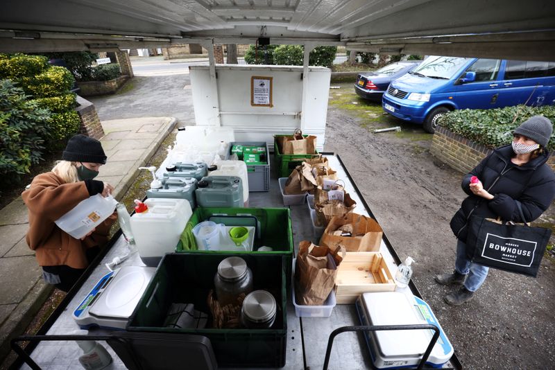 &copy; Reuters. Ella Shone, serves a customer from her mobile zero waste shop called the &apos;Top Up Truck&apos; in London