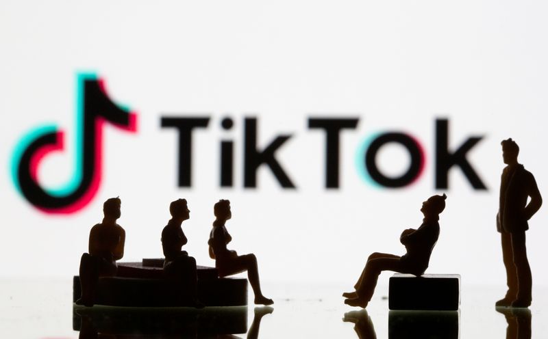 &copy; Reuters. Small toy figures are seen in front of a Tiktok logo in this illustration taken
