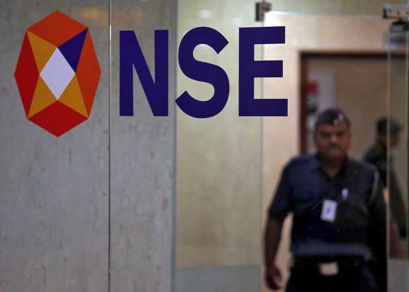 &copy; Reuters. FILE PHOTO: A security guard walks past the logo of the National Stock Exchange inside its building in Mumbai