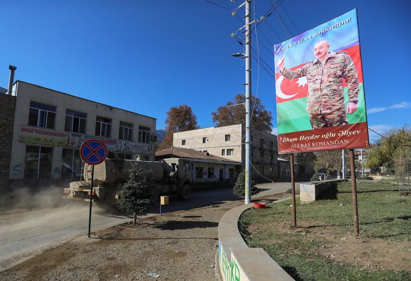 &copy; Reuters. A board with an image of Azeri President Ilham Aliyev is on display in the town of Hadrut in Nagorno-Karabakh