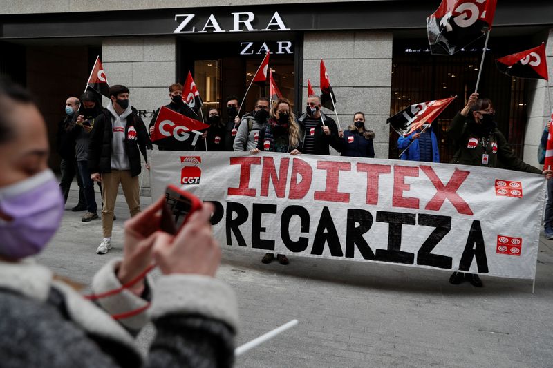&copy; Reuters. People hold flags from Spain&apos;s CGT labour union as they protest outside a Zara clothing store in Madrid