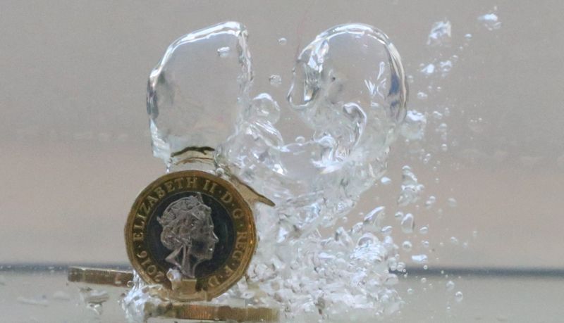 &copy; Reuters. UK pound coins plunge into water in this illustration picture