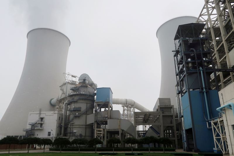 &copy; Reuters. FILE PHOTO: Water vapour rises from a cooling tower of a China Energy ultra-low emission coal-fired power plant during a media tour, in Sanhe