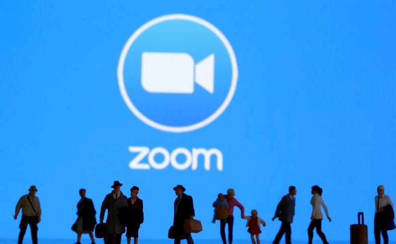 &copy; Reuters. FILE PHOTO: Small toy figures are seen in front of diplayed Zoom logo