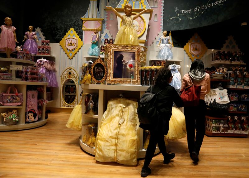 &copy; Reuters. FILE PHOTO: Customers look at &quot;Beauty and the Beast&quot; merchandise in a Disney Store in New York