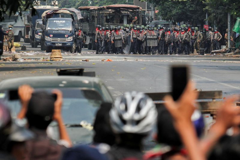 &copy; Reuters. Police stand on a road during an anti-coup protest in Mandalay