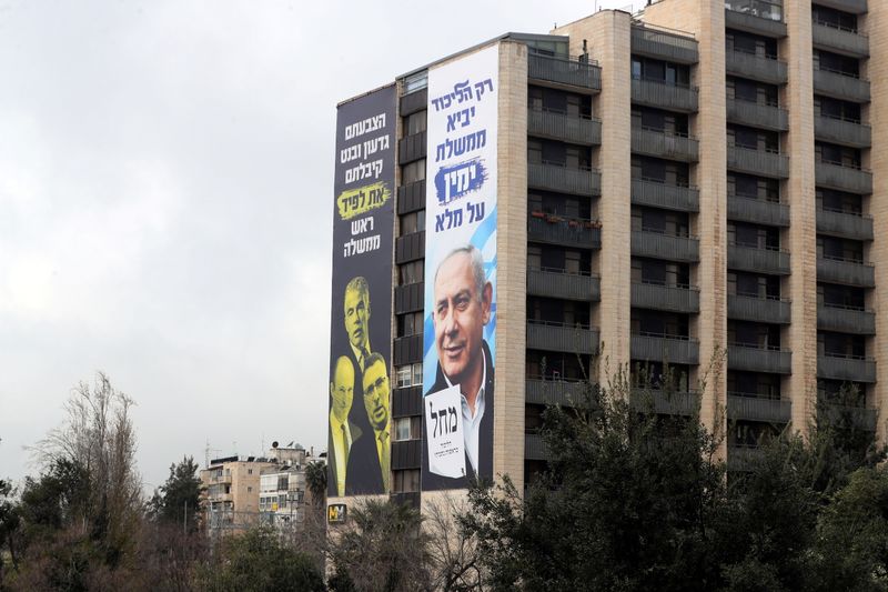 © Reuters. Election campaign posters by Israeli prime minister Benjamin Netanyahu's Likud Party are seen on a building in Jerusalem