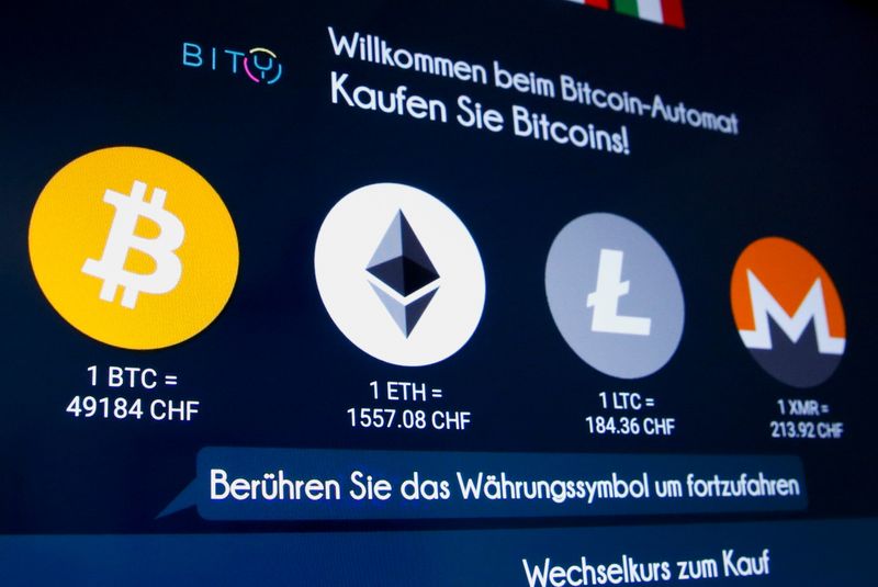 &copy; Reuters. The exchange rates and logos of Bitcoin, Ether, Litecoin and Monero are seen on the display of a cryptocurrency ATM in Zurich