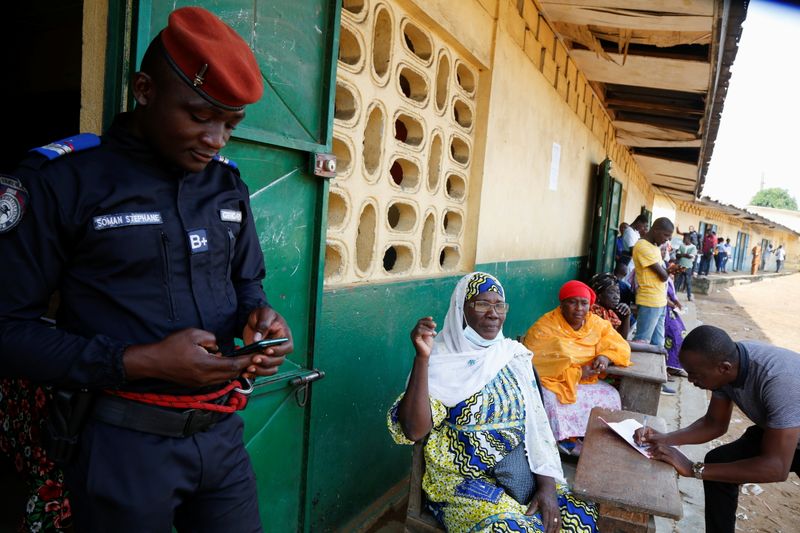 &copy; Reuters. People wait for the opening of a polling station during the legislative election in Abidjan