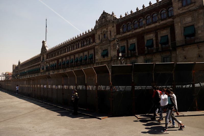 Mexican president defends 10-foot barriers to wall off women protesters