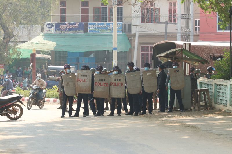 © Reuters. Security force officers hold shields in Nyaung-U