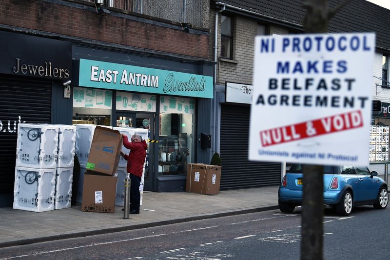 © Reuters. A sign is seen with a message against the Brexit border checks in relation to the Northern Ireland protocol in Larne