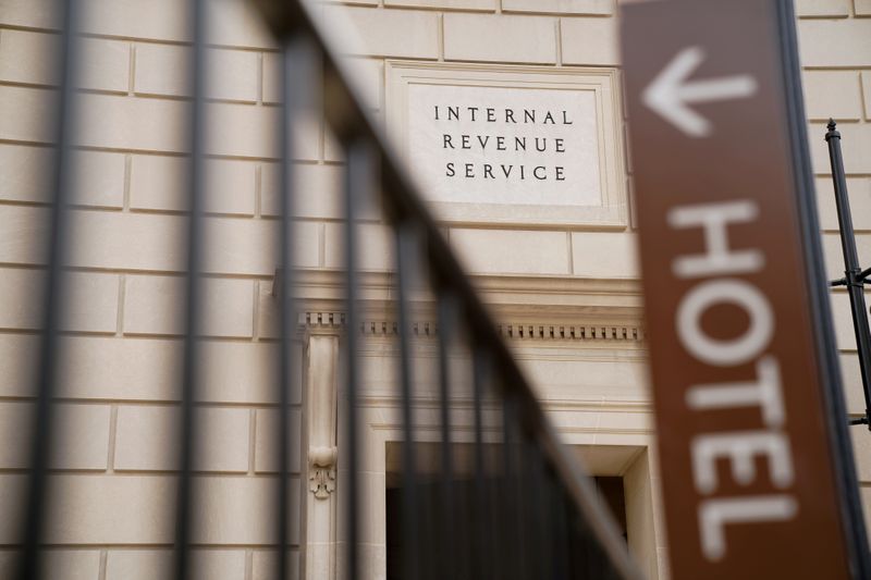 &copy; Reuters. FILE PHOTO: The Internal Revenue Service building is seen behind a sign for the Trump International Hotel