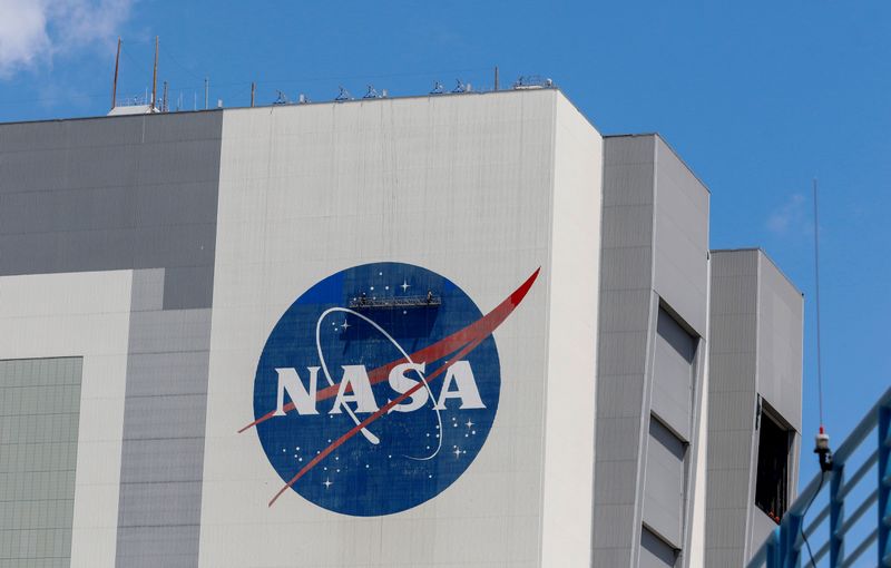 &copy; Reuters. Workers pressure wash the logo of NASA on the Vehicle Assembly Building, in Cape Canaveral