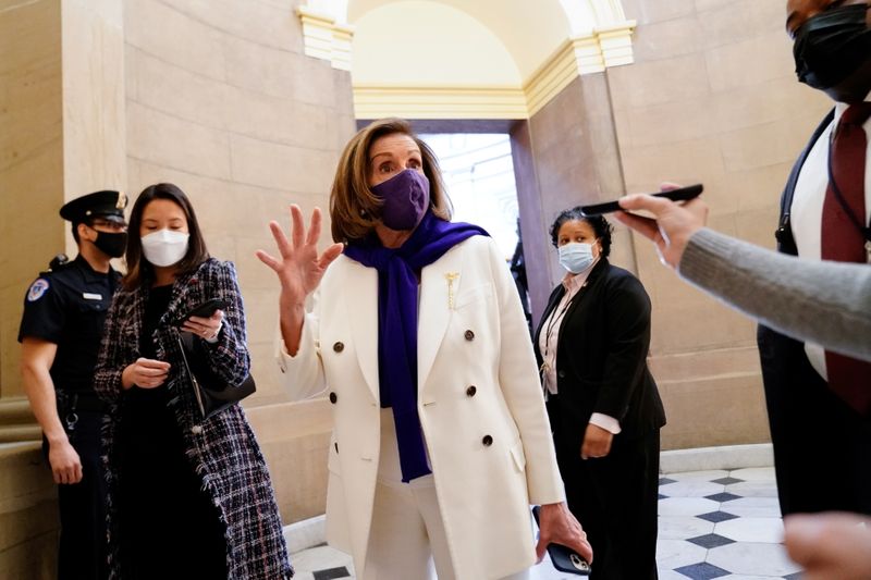 © Reuters. Speaker of the House Pelosi speaks to a reporter as the House takes up debate of the Senate's version of U.S. President Biden's COVID-19 relief plan in Washington