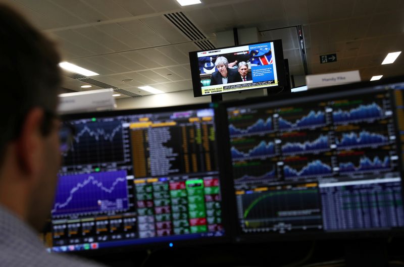 &copy; Reuters. FILE PHOTO: An investment manager, in the office of Aberdeen Standard Investments, watches his screen in London, Britain