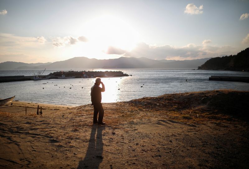 &copy; Reuters. 震災10年：「あの時、なぜ救えなかったのか」、遺族が抱き続ける悔悟と葛藤