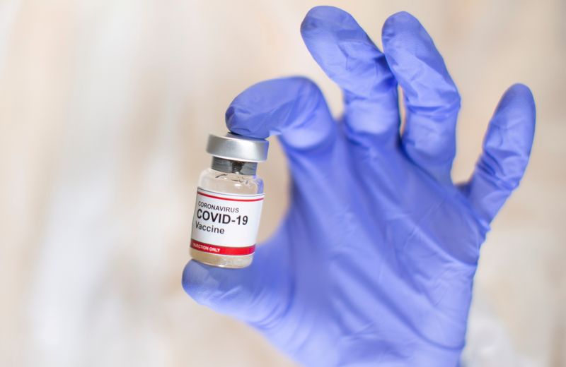 © Reuters. FILE PHOTO: A woman holds a small bottle labelled with a 