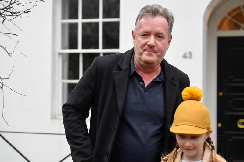 © Reuters. Piers Morgan walks with his daughter Elise in London