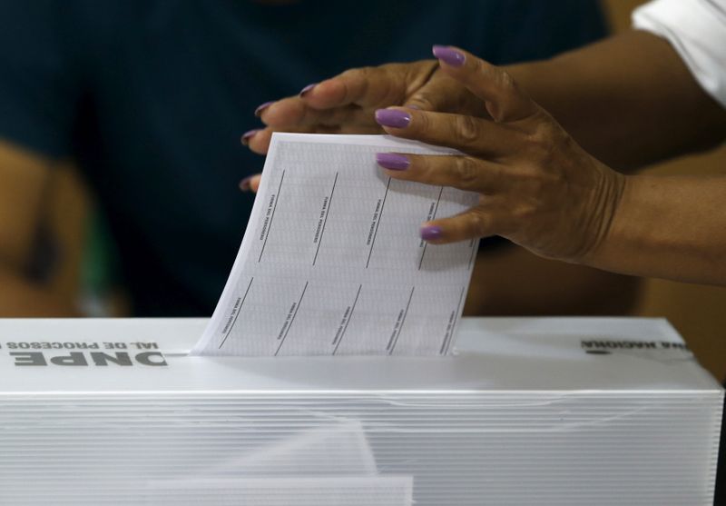 &copy; Reuters. FILE PHOTO: A woman casts her vote during presidential election at a polling station in Lima
