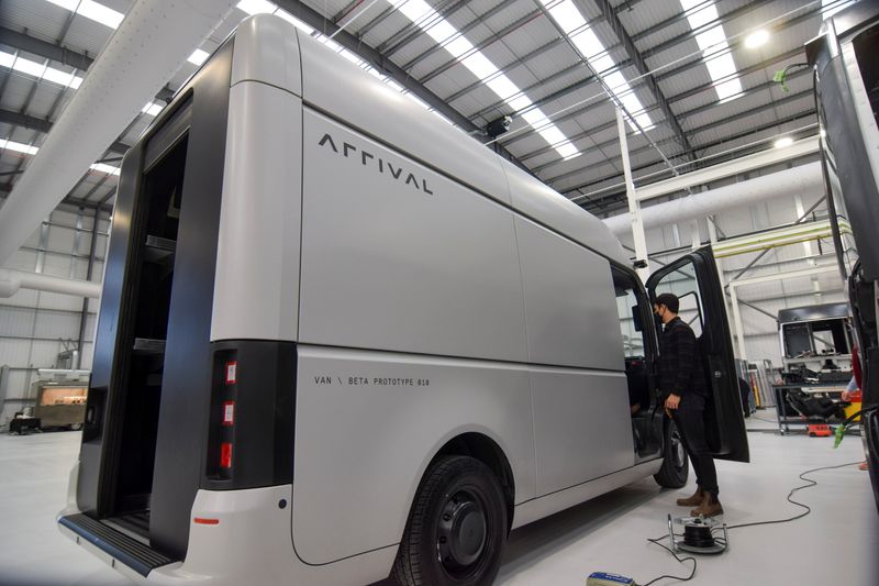 &copy; Reuters. A man stands next to a fully-electric test van, due to go into production in 2022, in Banbury