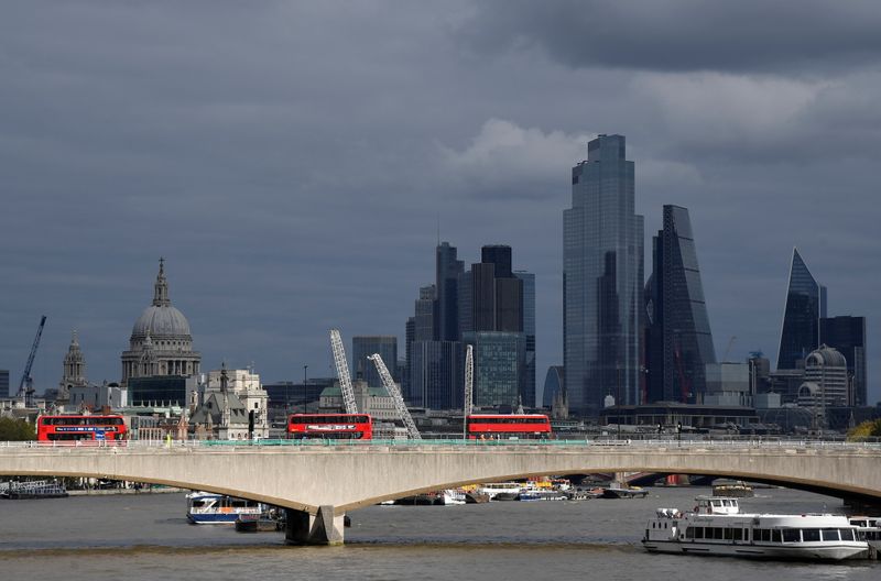 &copy; Reuters. London buses cross Waterloo Bridge as St Paul&apos;s Cathedral is seen together with skyscrapers in the City of London financial district