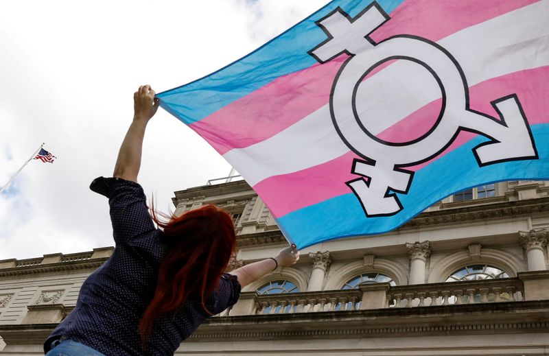 © Reuters. FILE PHOTO: A person holds up a flag during rally to protest the Trump administration's reported transgender proposal to narrow the definition of gender to male or female at birth in New York