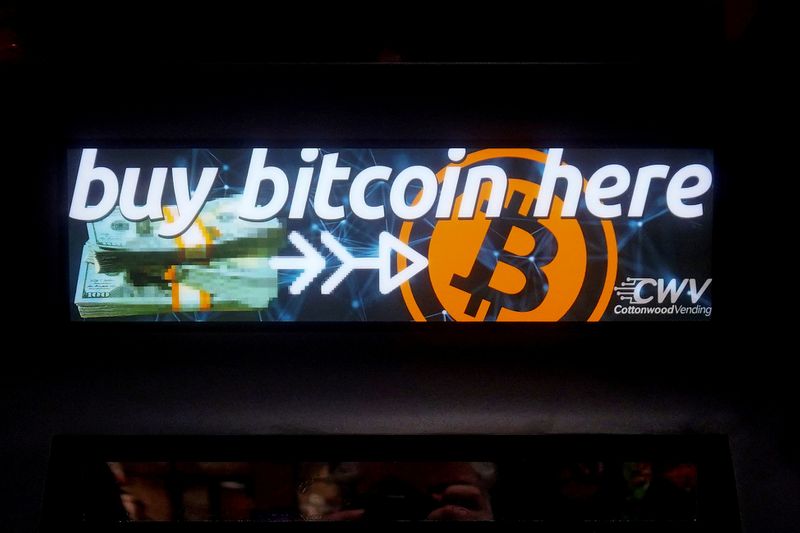 © Reuters. FILE PHOTO: A Bitcoin ATM sign is pictured in a bodega in New York
