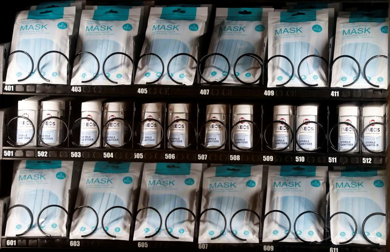 &copy; Reuters. Face masks and hand sanitiser are seen for sale in a vending machine inside the terminal building of Manchester Airport amid the outbreak of the coronavirus disease (COVID-19) in Manchester