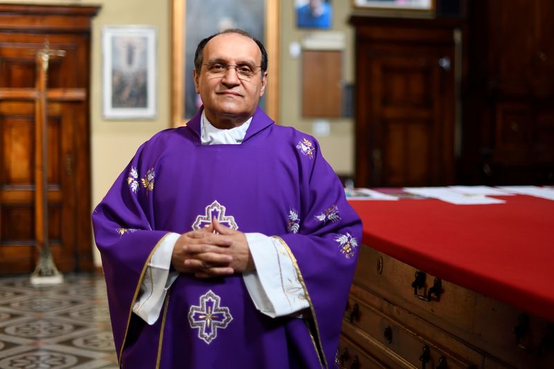 &copy; Reuters. Italy small town priest who dealt with death on an industrial scale, one year on