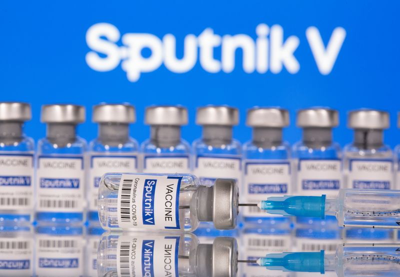 &copy; Reuters. Vials labelled &quot;Sputnik V Coronavirus COVID-19 Vaccine&quot; and a syringe are seen in front of a displayed Sputnik V logo, in this illustration photo
