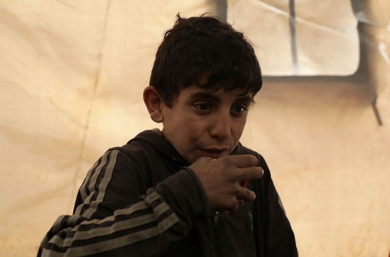 &copy; Reuters. لم يعرف غير الحرب .. طفل سوري في العاشرة يعول أسرته