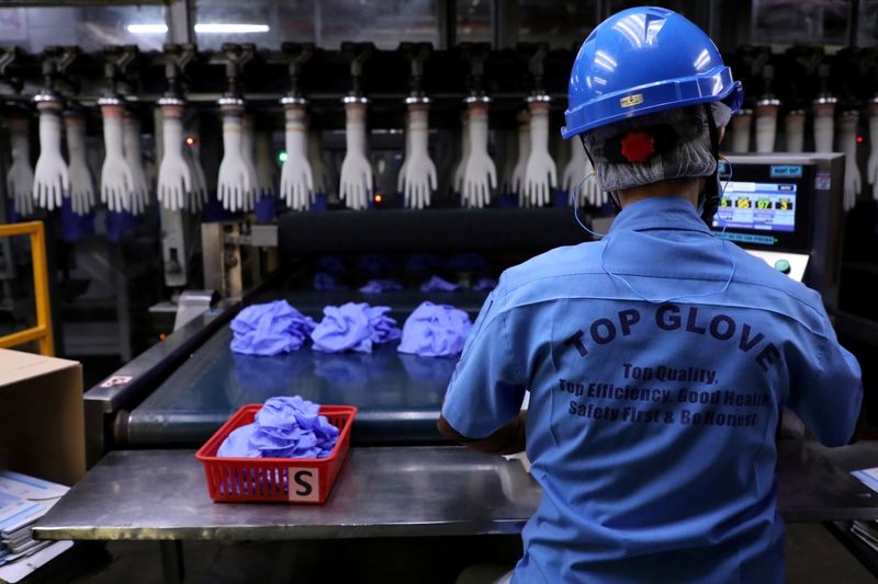 &copy; Reuters. FILE PHOTO: A worker works at a production line in Top Glove factory in Shah Alam