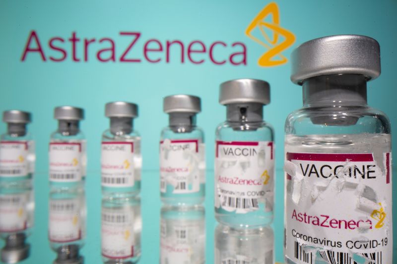 &copy; Reuters. FILE PHOTO: Vials labelled with partially torn sticker &quot;AstraZeneca COVID-19 Coronavirus Vaccine&quot; are seen in front of a displayed AstraZeneca logo in this illustration