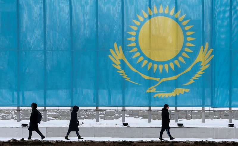 &copy; Reuters. People walk past a gaint Kazakhstan&apos;s flag in Astana