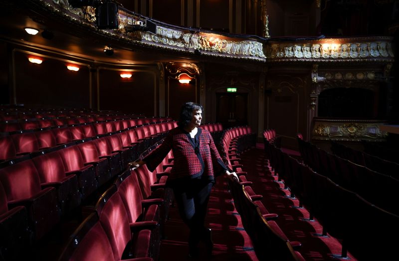 © Reuters. Nica Burns poses inside the Apollo Theatre, one of the several theatres she owns, on Shaftesbury Avenue, in London