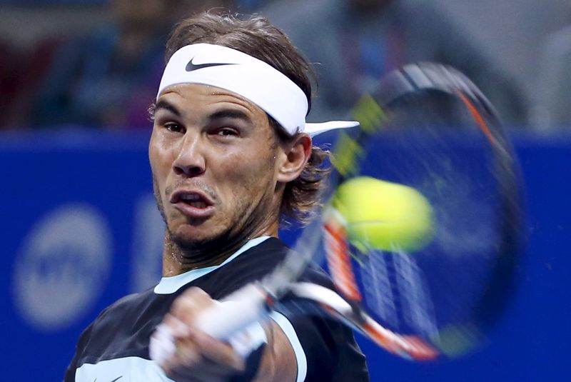 © Reuters. Nadal of Spain hits a return to Djokovic of Serbia during the men's singles final match at the China Open Tennis Tournament in Beijing