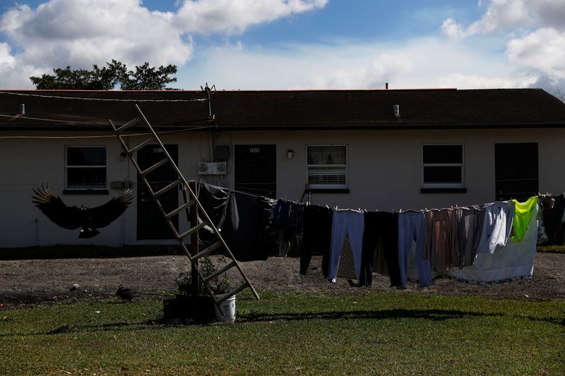 &copy; Reuters. Clothes hang outside to dry behind an apartment as a buzzard flies during the spread of the coronavirus disease (COVID-19) in West Belle Glade, Florida