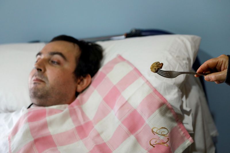 &copy; Reuters. Rafael Botella, 35, tetraplegic since he was 19 after a car crash where his girlfriend died, is fed by his mother Maria Luisa, 73, at his home in Simat de la Valldigna