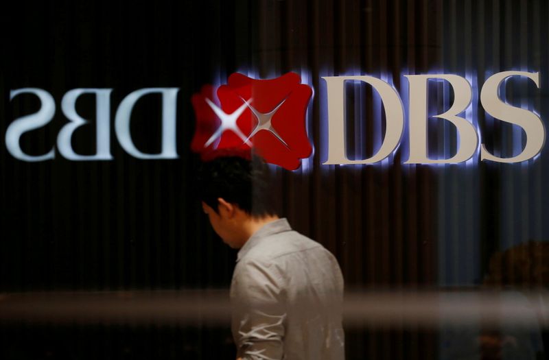 &copy; Reuters. FILE PHOTO: A man walks past DBS signage in Singapore