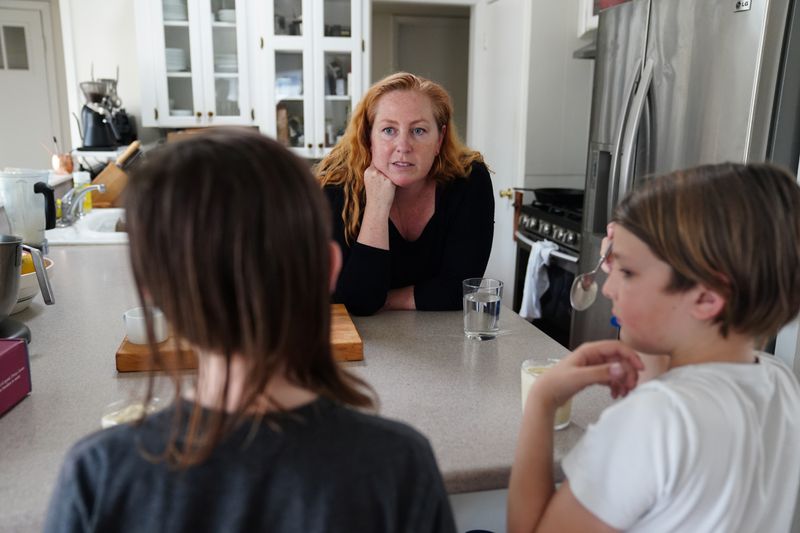 &copy; Reuters. Kate Sullivan Morgan plays with her children