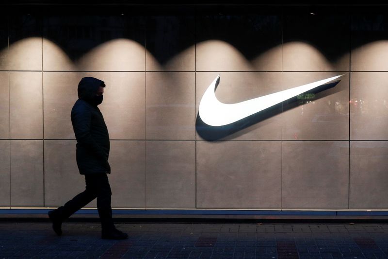 © Reuters. A man walks past a Nike brand store in Kyiv