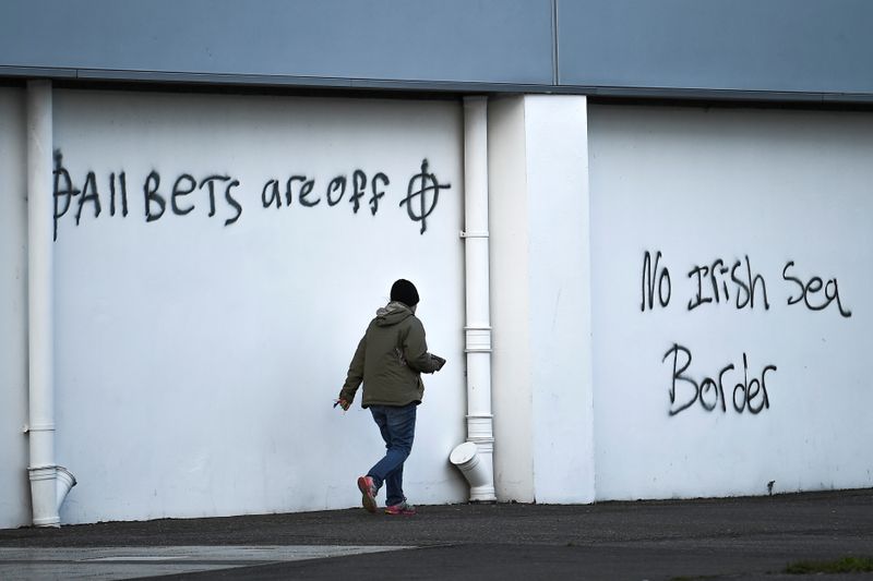 &copy; Reuters. Loyalist graffitis are seen with messages against the Brexit border checks in relation to the Northern Ireland protocol at the harbour in Larne