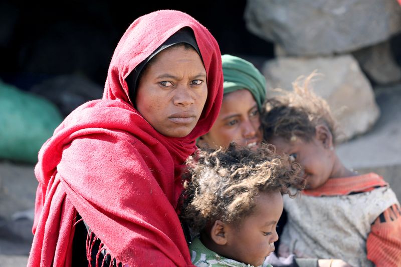 &copy; Reuters. FILE PHOTO: Woman looks as she sits with her children at a camp for internally displaced people on the outskirts of Sanaa