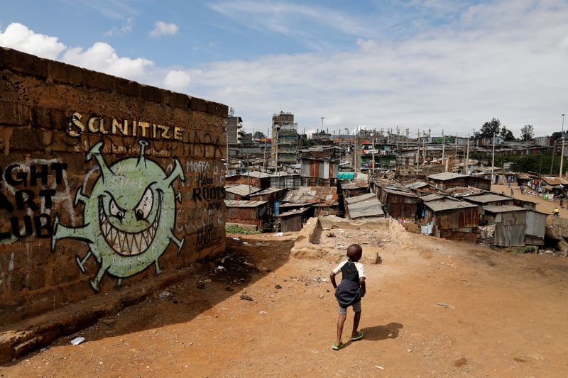 &copy; Reuters. FILE PHOTO: FILE PHOTO: A boy walks in front of a graffiti promoting the fight against the coronavirus disease in the Mathare slums of Nairobi